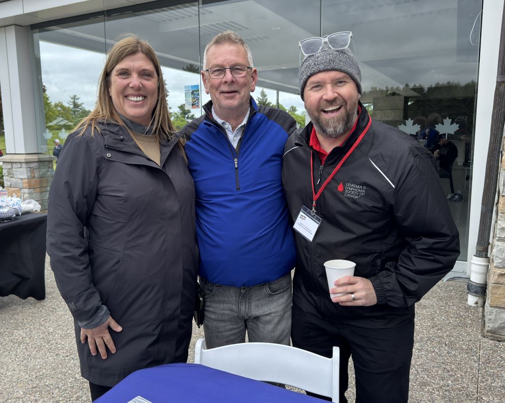 President Kelly Tosato and Secretary-Treasurer Jim McLean stand together with Ryan O'Quinn from the LLSC.