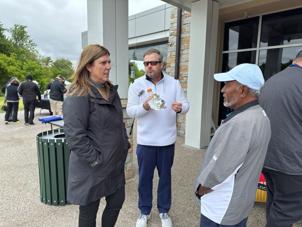 President Kelly Tosato talks to the golfers during the Locals annual golf tournament 2025.