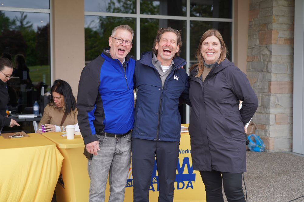 President Kelly Tosato and Secretary-Treasurer Jim McLean stand together with a golfer at the Locals tournament 2025.