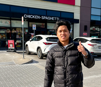 Rafael smiling and posing in front of the camera.
