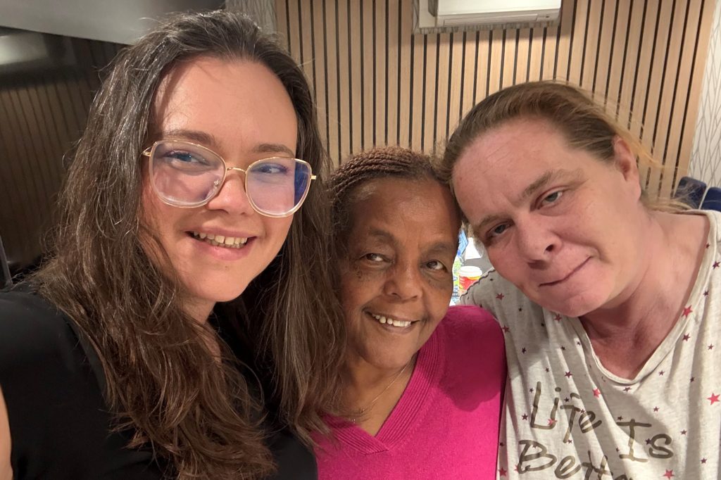Three women pose for a selfie at a Union Ratification Meeting