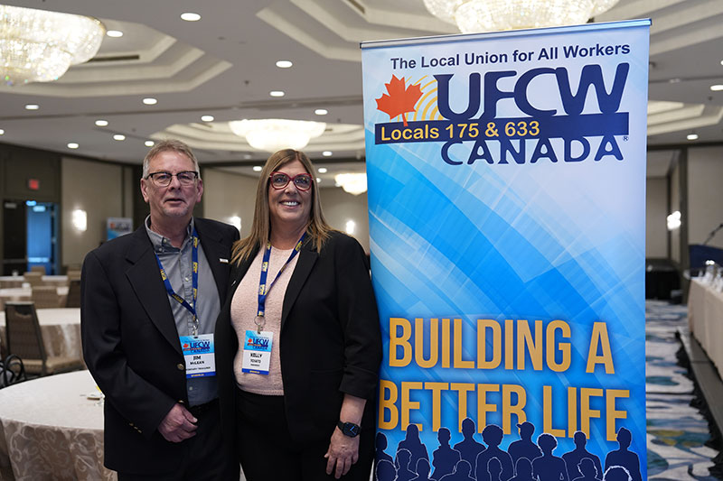 President Tosato and Secretary-Treasurer McLean stand next to a Union banner