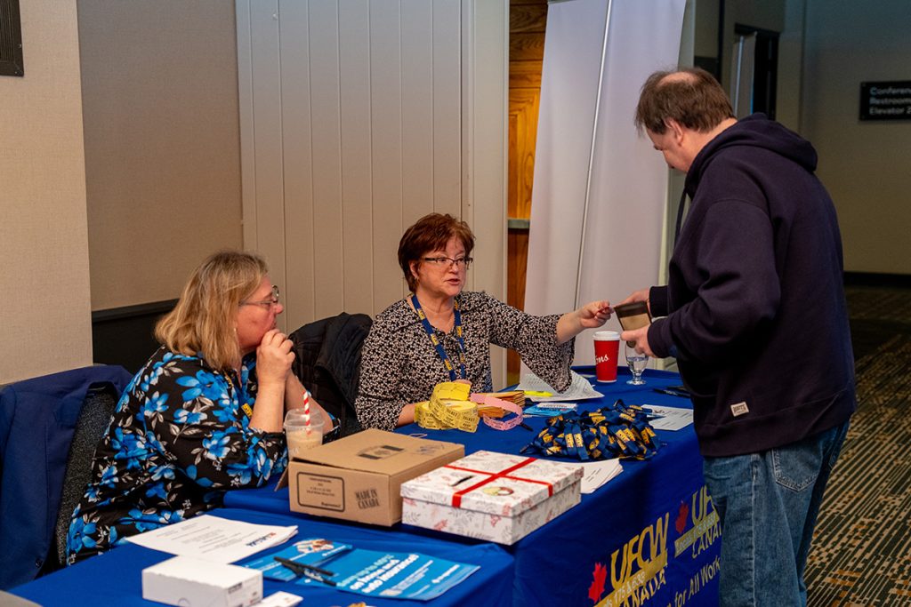 Registration desk giving out drink tickets to stewards.