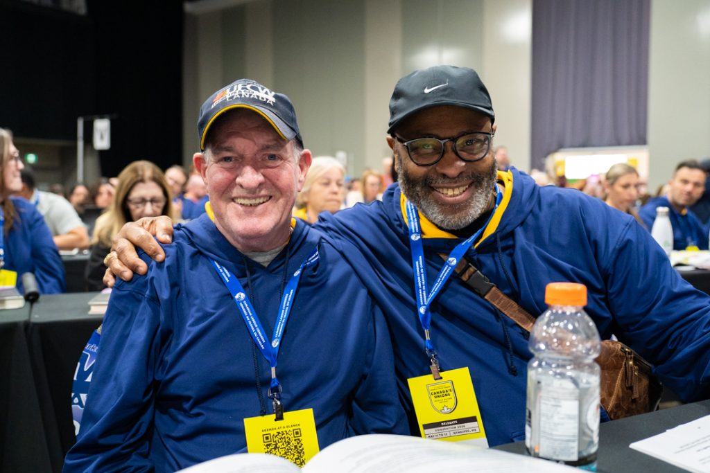2 people smile warmly, wearing UFCW gear, at the CLC COnvention