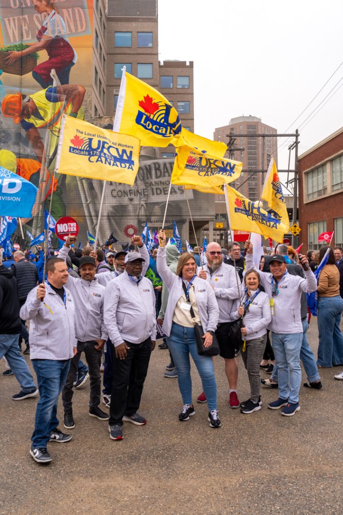 President Tosato and delegates holding UFCW flags at a rally in Winnipeg for the 2026 CLC Convention