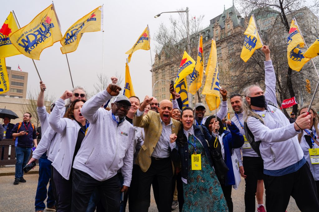 a group of CLC delegates rally during a group photo