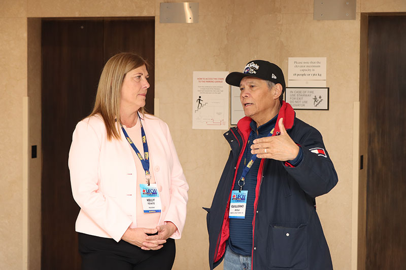 President Tosato speaks to an Eboard Vice President who gestures with a hand