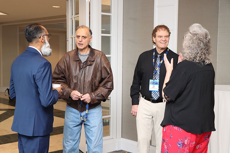 2 groups of 2 people talking in a foyer area at a hotel