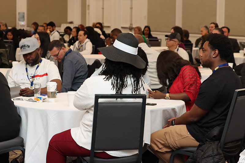 20+ union stewards seated at various banquet tables in a hotel meeting space