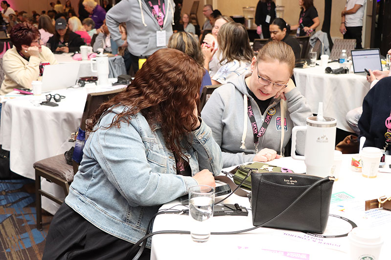2 delegates review materials during a workshop
