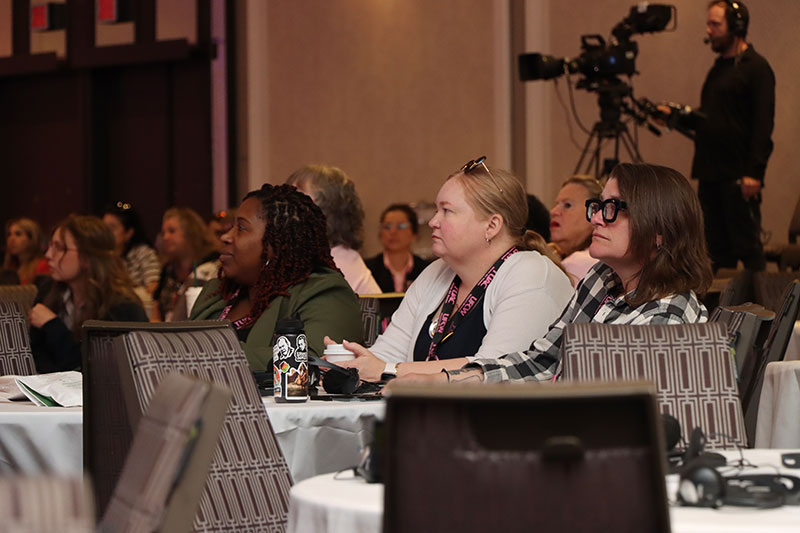 3 delegates look ahead during a workshop session