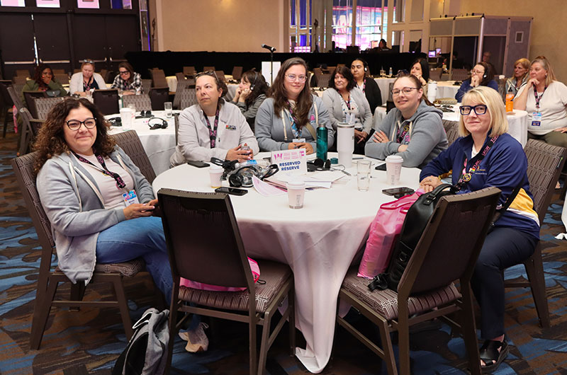 5 delegates seated at a table during a workshop