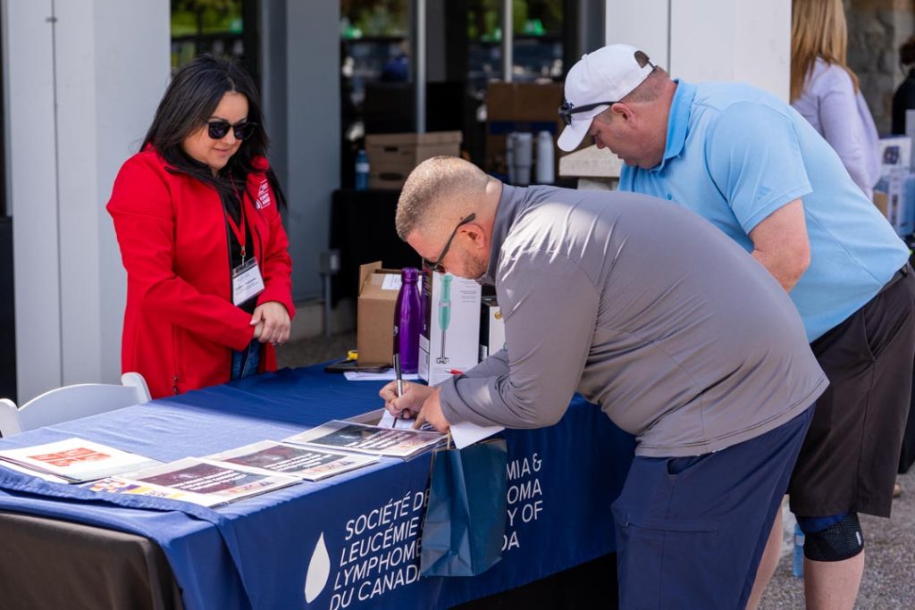 Christina from the Leukemia & Lymphoma Society of Canada signs up members for her raffle.