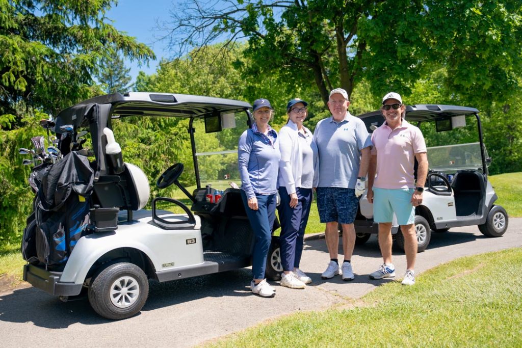 The UFCW Locals 175 & 633 participants standing by their golf carts.