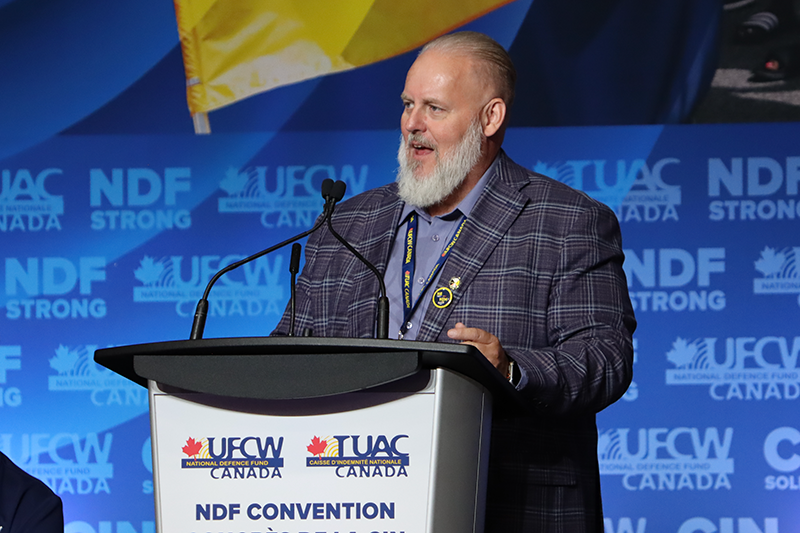 UFCW International Secretary-Treasurer Shawn Haggerty speaks from a podium on stage at the 2026 NDF Convention
