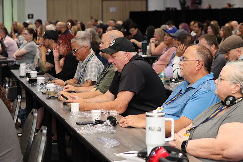 A row of about 8 UFCW delegates seated in the audience at the convention