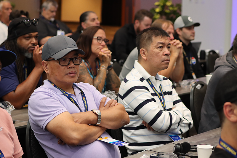 focus on two people seated as delegates at the NDF Convention