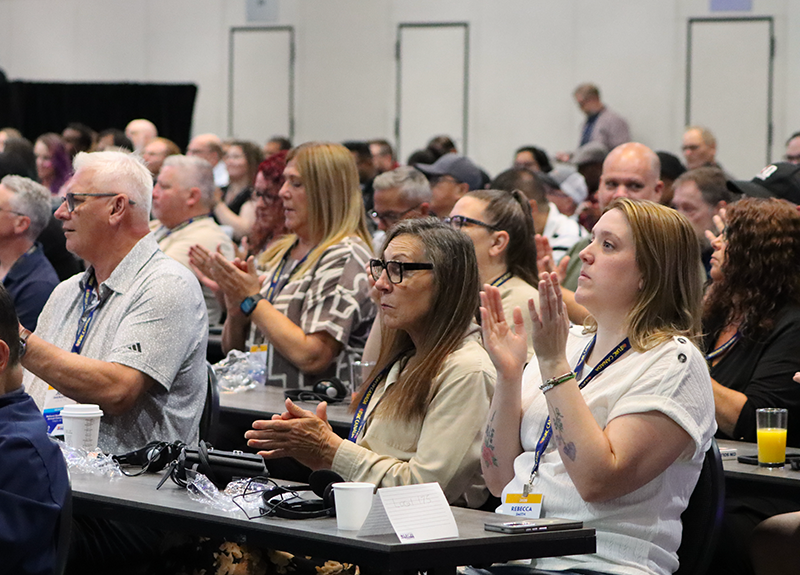 a group of UFCW delegates and President Tosato applaud following a presentation at the 2026 NDF Convention