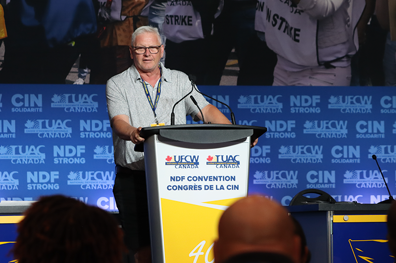 A UFCW delegate speaks from the podium during a sector presentation