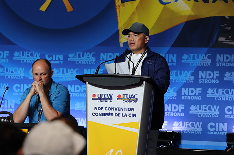 A UFCW delegate speaks from the podium during a sector presentation