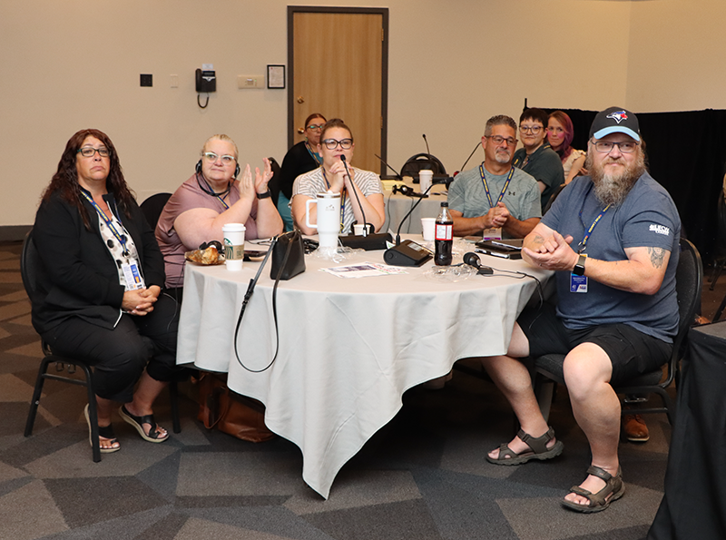 Five UFCW delegates seated at a table in the retail sector meeting