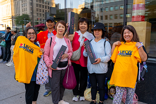6 people showing off their union tshirts and logo'd speakers