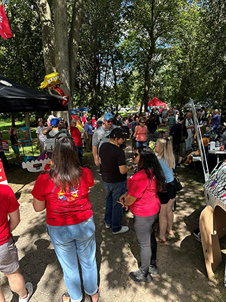 numerous people chatting, standing, walking in the park at Guelph Labour Day