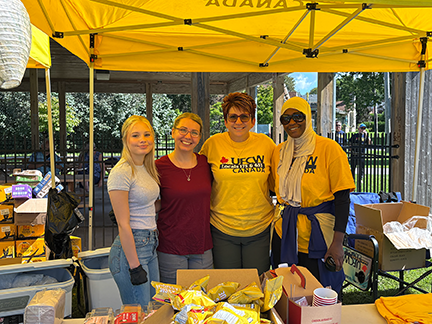 four people pose together at the ufcw tent in Cobourg